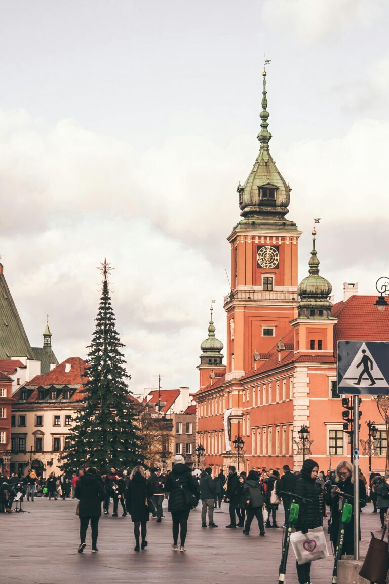 Capturing Warsaw's historic Old Town square adorned with festive decorations under a winter sky.